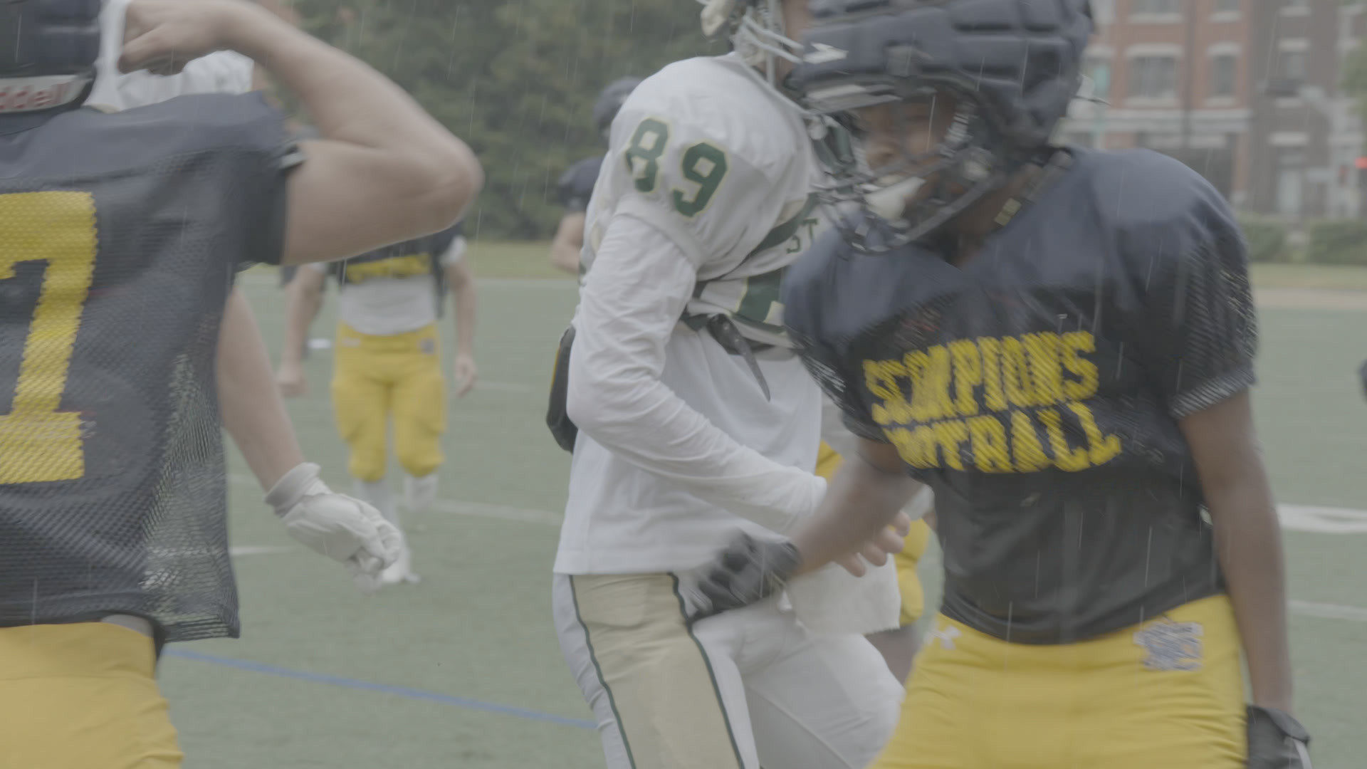 Two football players in navy and white jerseys, shot on a Sony FX30 in S-Log3, flat as recorded