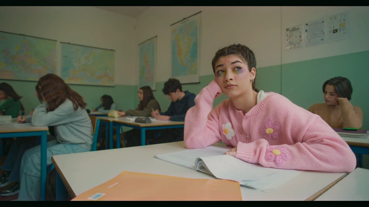 The same classroom frame after a darker, warmer Leumos reference match